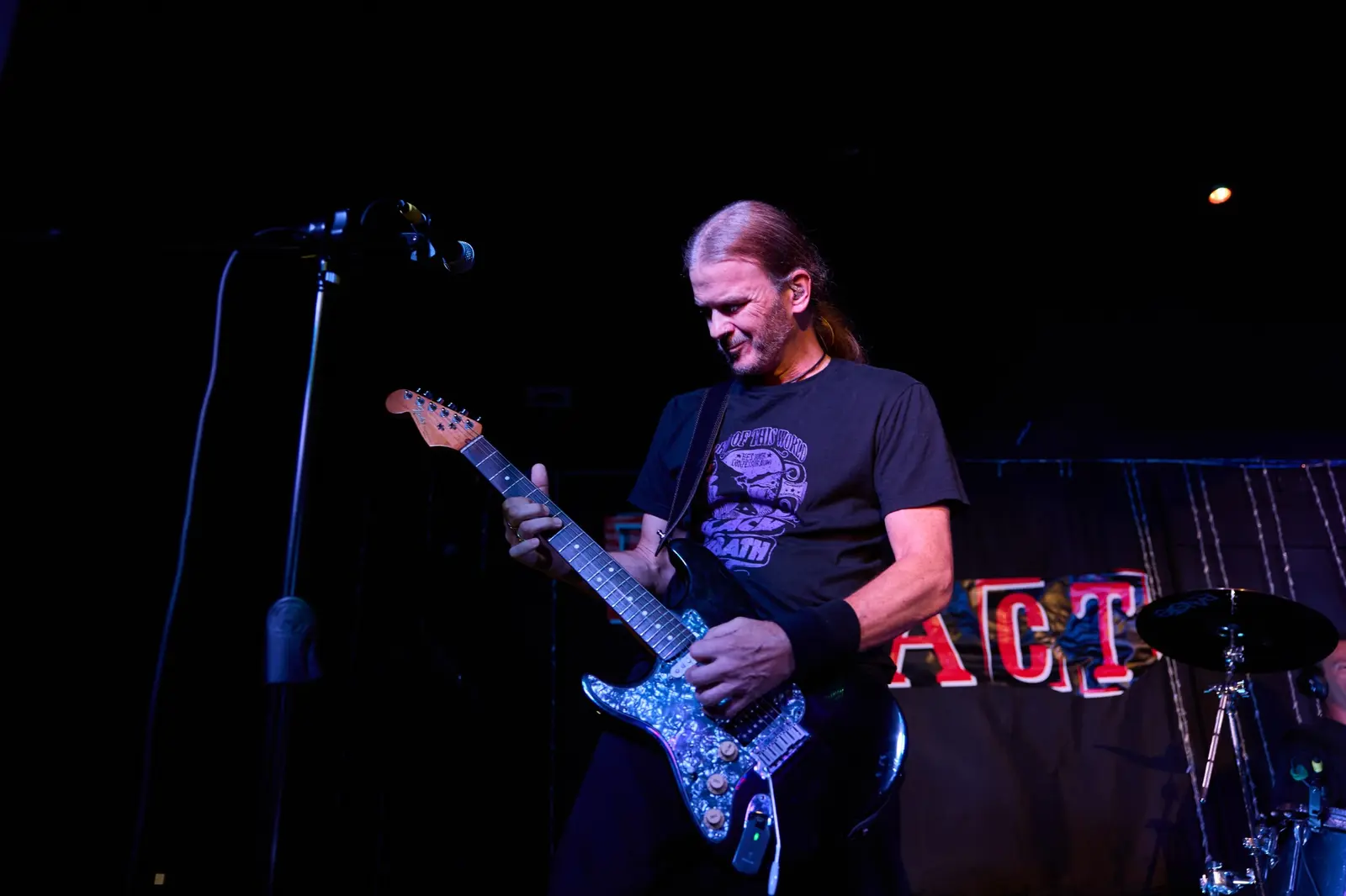 Guitarist performing on a dark stage